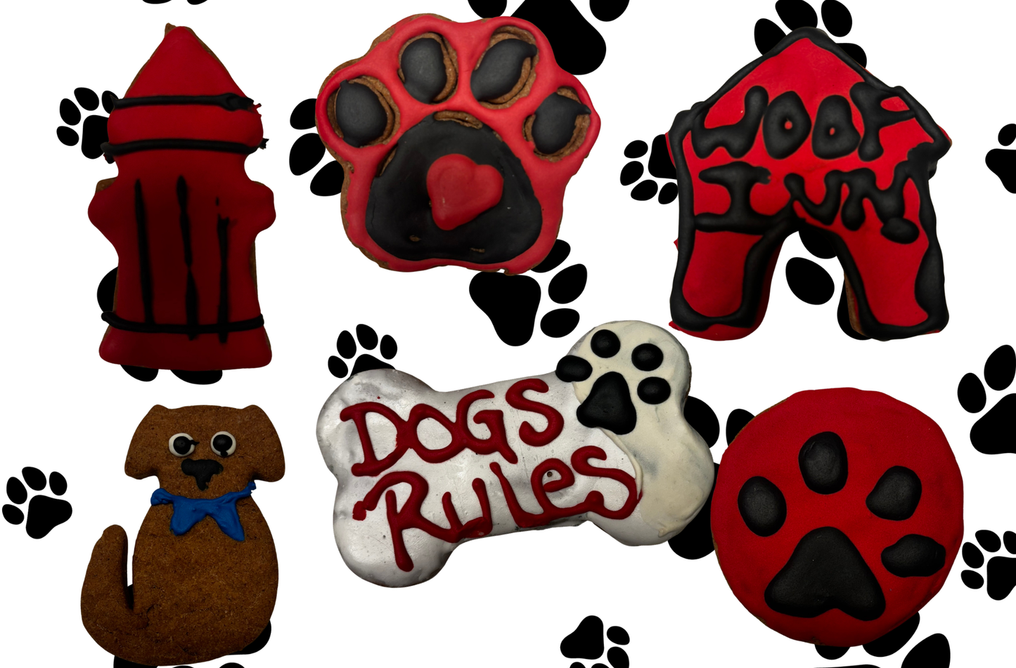 Organic dog cookies with red and black icing on paw print background, including dog bone “Dogs Rule” cookie, paw shapes, and themed dog treats