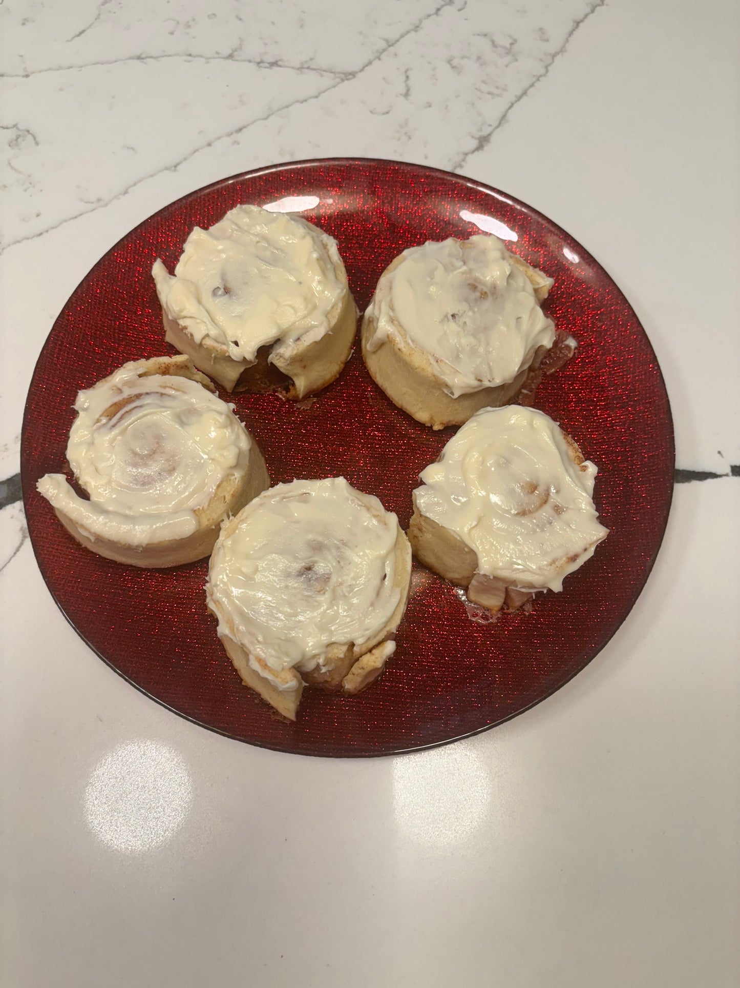 cinnamon bun-shaped organic dog treats with icing on top, delicious and sweet.