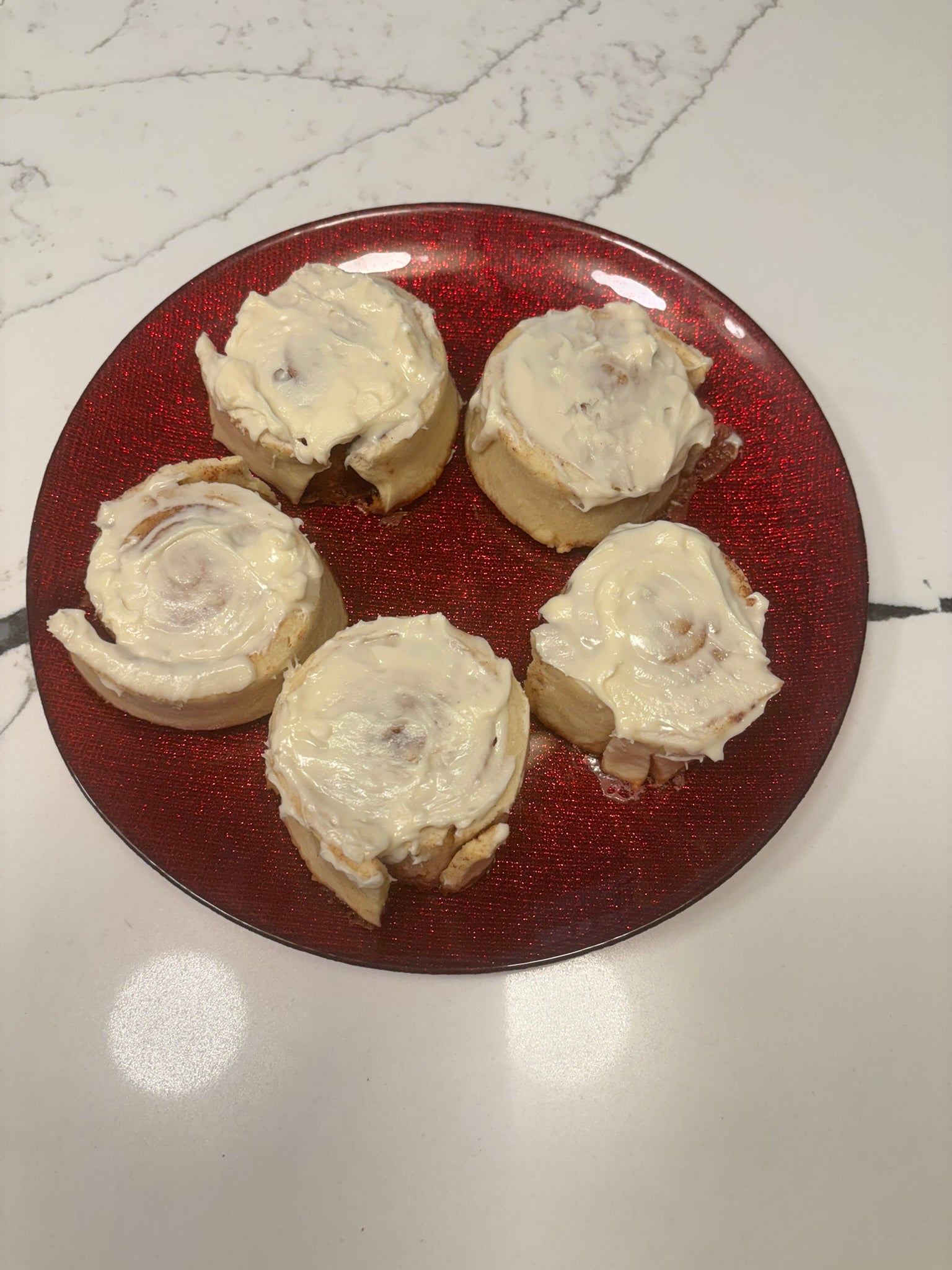 cinnamon bun-shaped organic dog treats with icing on top, delicious and sweet.