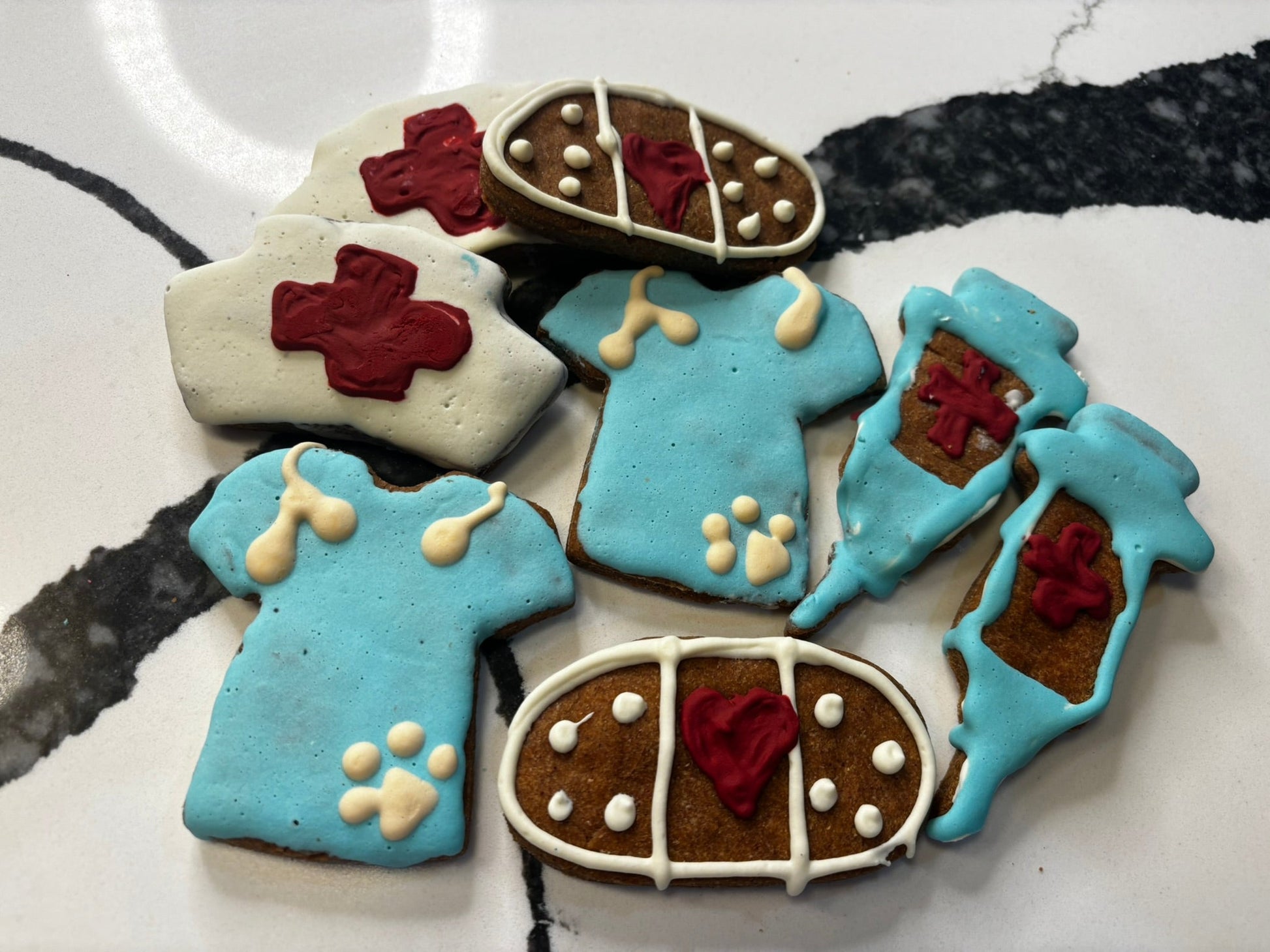 decorated dog cookies with icing paw prints and crosses organic treats