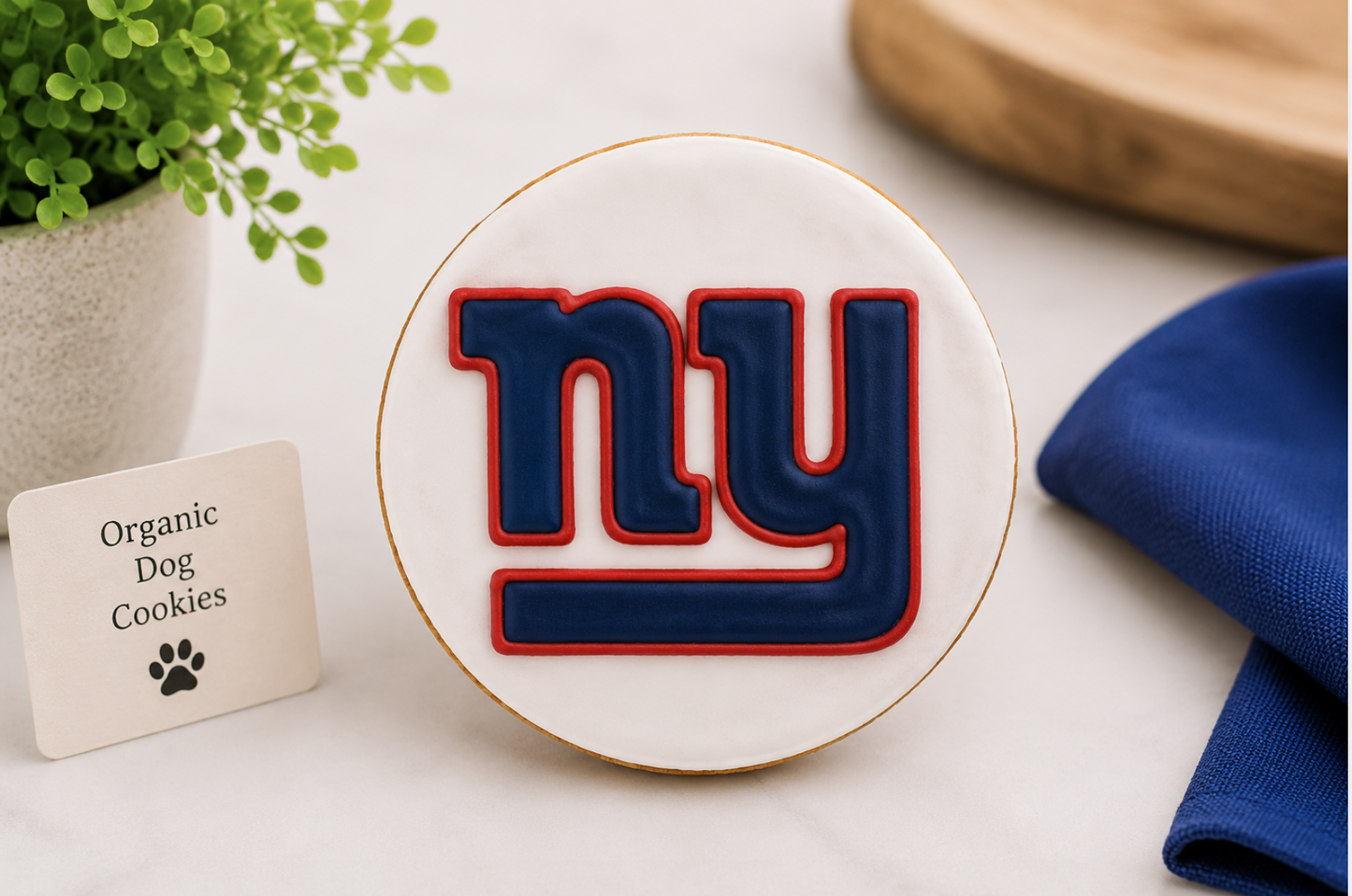 Hand-decorated New York Giants dog cookie featuring the iconic "NY GIANTS" logo in team colors on white icing, made with organic peanut butter and styled in a professional sports-themed setting.

Generic Sports Team Collection Image