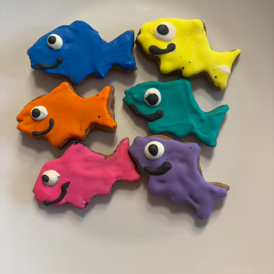 Colorful fish-shaped PAWaquarium dog treats made with organic peanut butter and cinnamon.